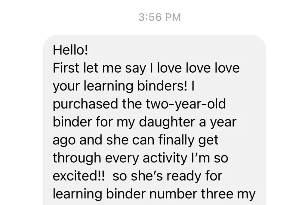 Toddler playing with binder game pieces