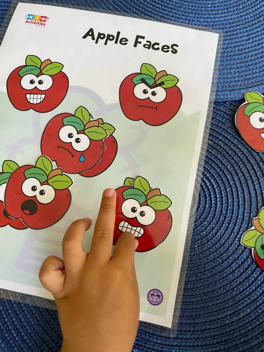 Emotions matching activity — apple faces showing happy, sad, mad, and surprised